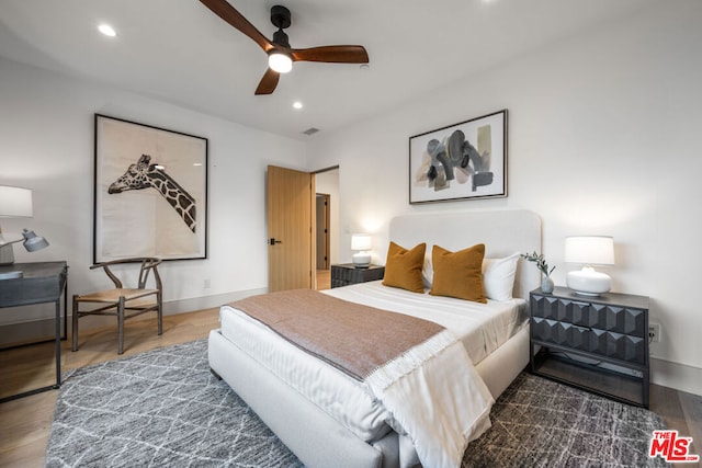 bedroom featuring ceiling fan and dark hardwood / wood-style flooring