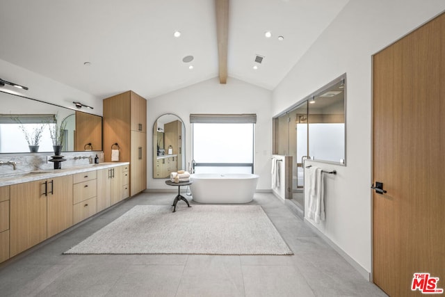 bathroom with vanity, a bathtub, and vaulted ceiling with beams