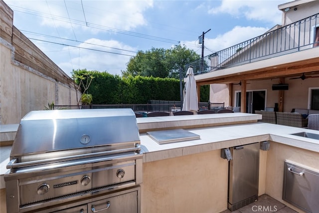 view of patio featuring area for grilling, a grill, and ceiling fan