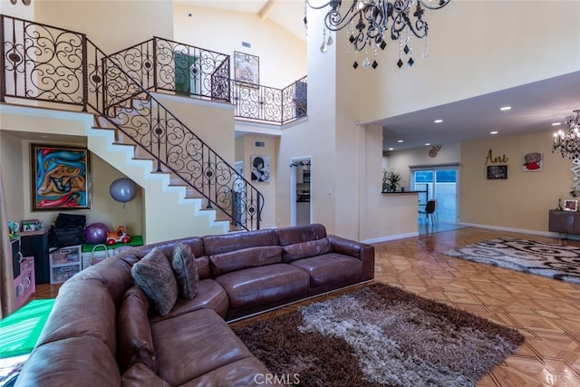 living room with beamed ceiling, a chandelier, and high vaulted ceiling