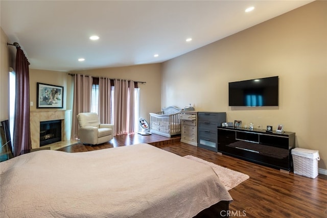 bedroom with dark wood-type flooring and lofted ceiling