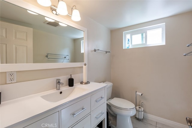 bathroom featuring tile patterned floors, vanity, and toilet