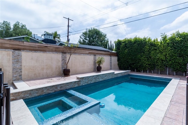 view of swimming pool featuring an in ground hot tub