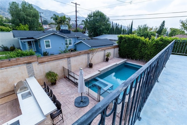 view of pool featuring area for grilling and a patio