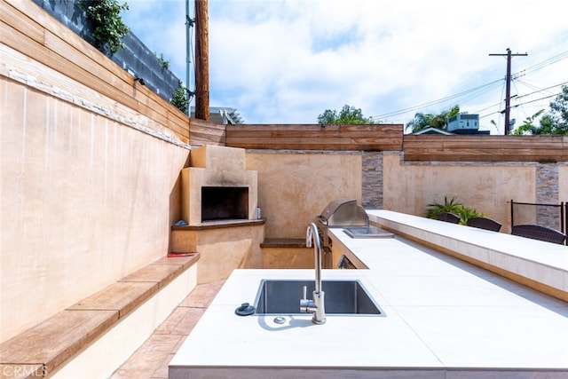 view of patio / terrace with sink, grilling area, and exterior kitchen