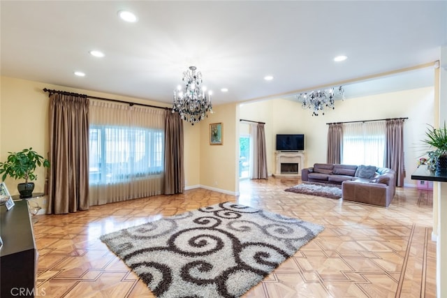 living room with light parquet flooring and an inviting chandelier