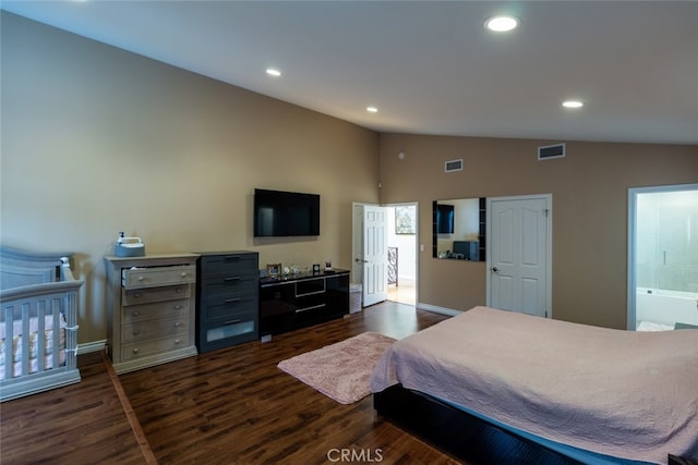 bedroom featuring connected bathroom, dark hardwood / wood-style floors, and vaulted ceiling