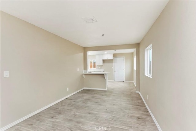 unfurnished living room with light hardwood / wood-style flooring