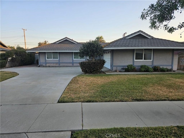 ranch-style house featuring a front lawn and a garage