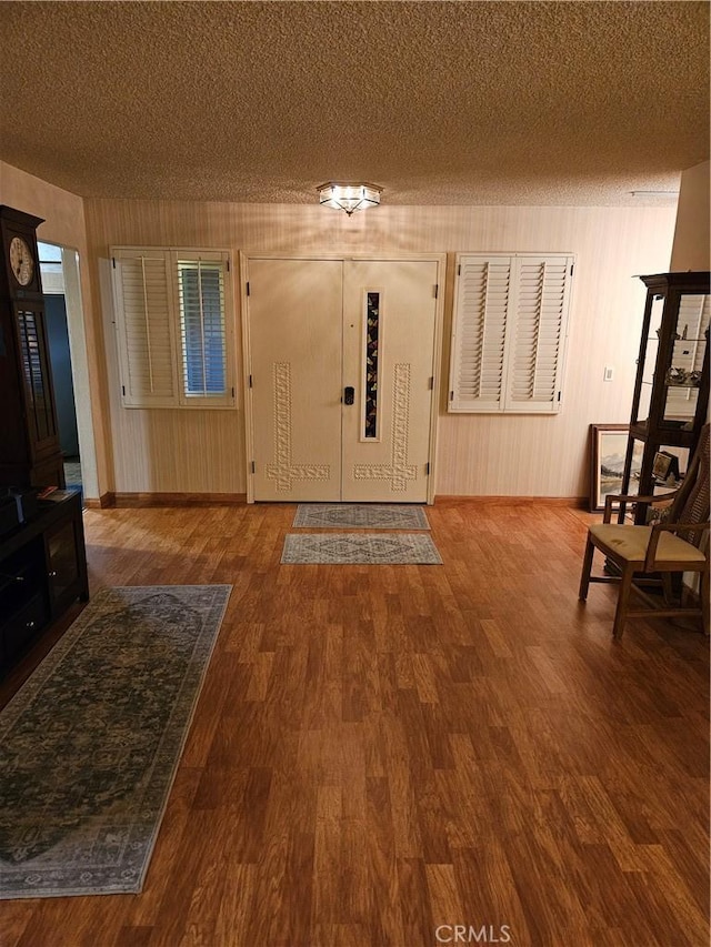 foyer entrance with a textured ceiling and hardwood / wood-style floors