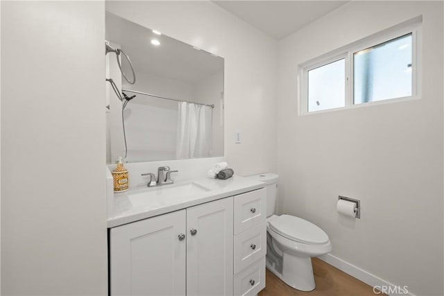 bathroom with toilet, vanity, wood-type flooring, and a shower with curtain