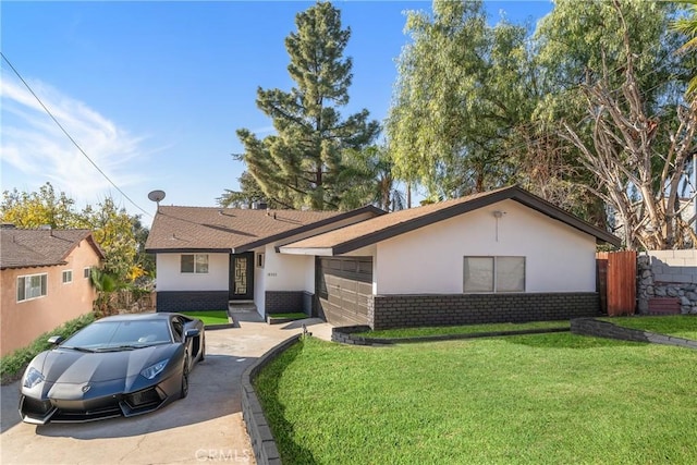 single story home with a garage and a front lawn