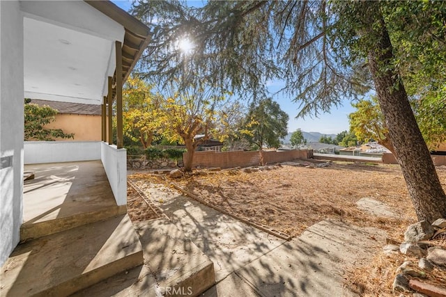 view of yard featuring a patio area and a mountain view