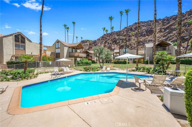 view of pool featuring a mountain view and a patio