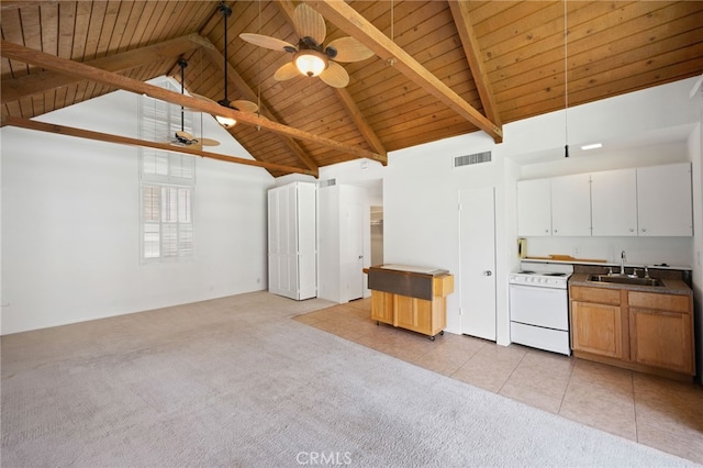 kitchen with sink, hanging light fixtures, high vaulted ceiling, white range oven, and white cabinets