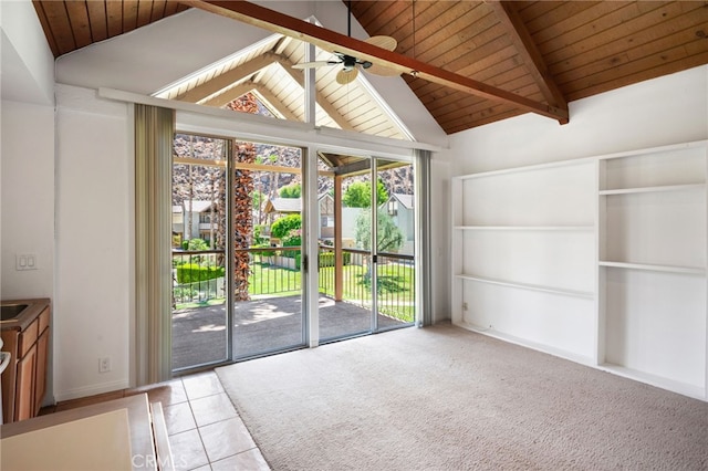 interior space featuring beam ceiling, high vaulted ceiling, a wealth of natural light, and ceiling fan