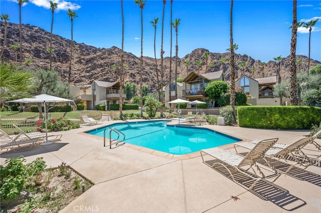 view of swimming pool featuring a mountain view and a patio