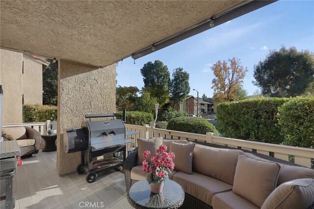 balcony with an outdoor living space and grilling area