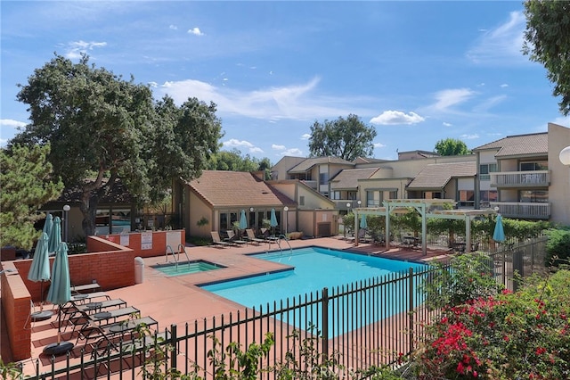 view of swimming pool featuring a patio, a hot tub, and a pergola