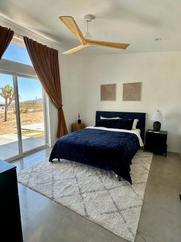 bedroom featuring ceiling fan and access to exterior