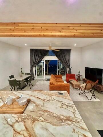 living room featuring beamed ceiling