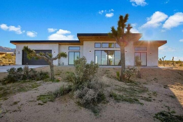 rear view of property featuring a garage