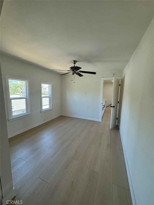 spare room featuring ceiling fan and light wood-type flooring