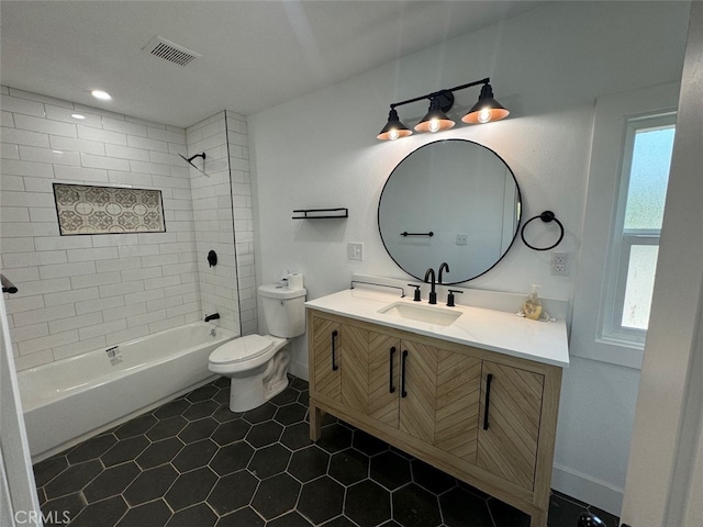 full bathroom featuring toilet, tiled shower / bath combo, tile patterned flooring, and vanity