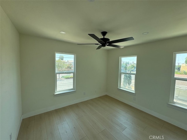 unfurnished room featuring light hardwood / wood-style floors and ceiling fan