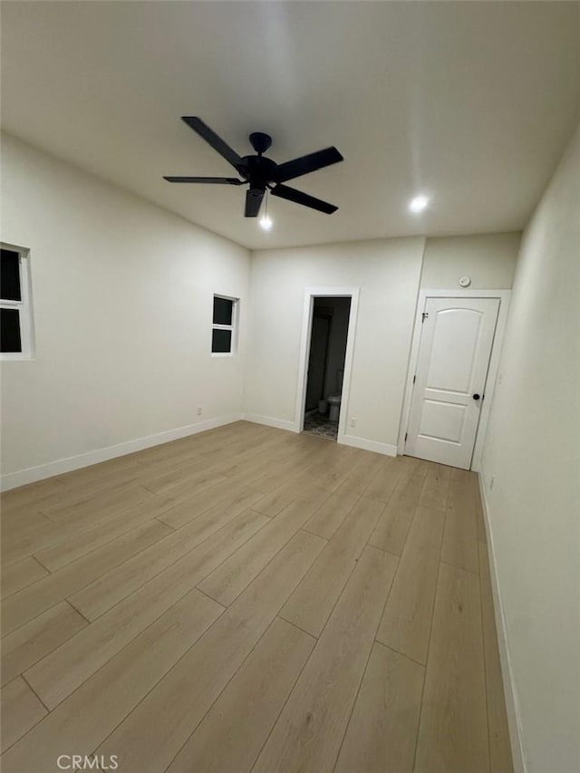 spare room featuring ceiling fan and light hardwood / wood-style floors