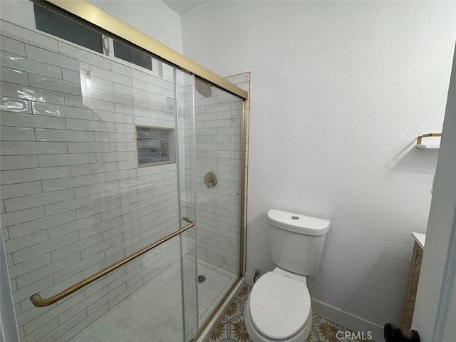 bathroom with toilet and a shower with door