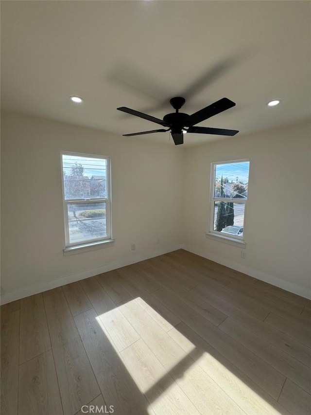 unfurnished room featuring light hardwood / wood-style floors and ceiling fan