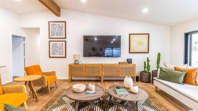 living room with vaulted ceiling with beams and hardwood / wood-style floors