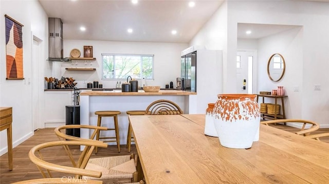 dining space with wood-type flooring