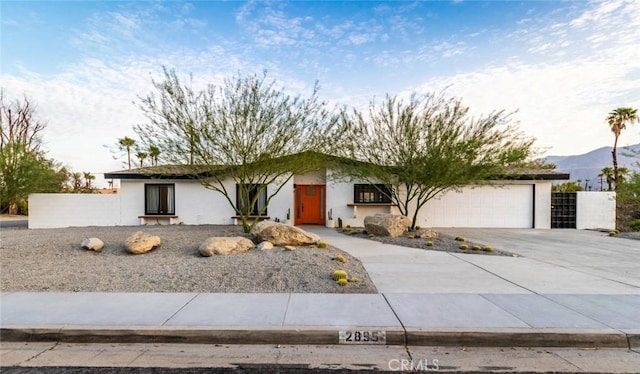 view of front of home with a mountain view and a garage