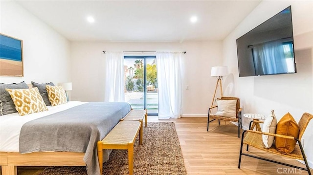 bedroom featuring access to outside and light hardwood / wood-style floors