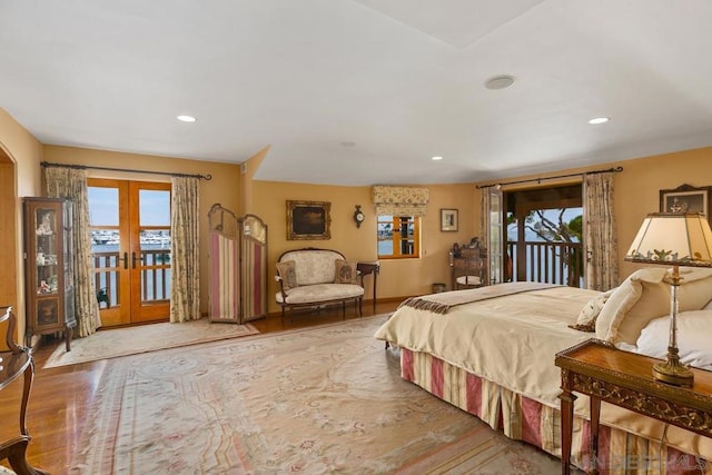 bedroom with hardwood / wood-style flooring, access to exterior, and french doors