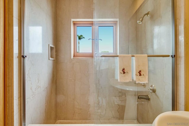 bathroom with a shower with door