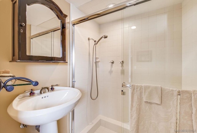 bathroom with sink and tiled shower