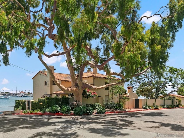 mediterranean / spanish-style house featuring a water view