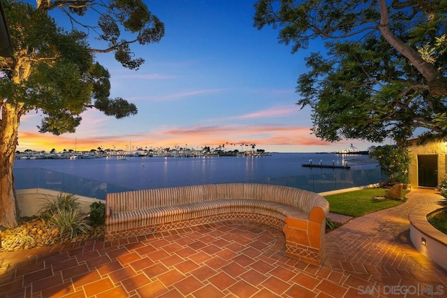 patio terrace at dusk with a water view