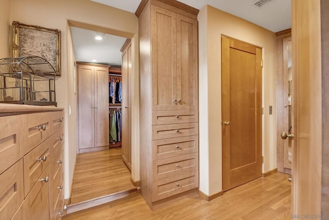 hallway with light hardwood / wood-style flooring