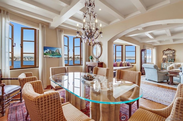 dining area featuring coffered ceiling, beamed ceiling, a notable chandelier, and hardwood / wood-style flooring