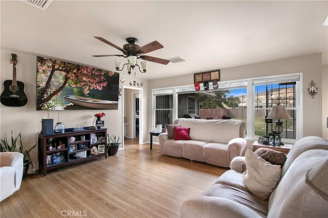 living room featuring light wood-type flooring and ceiling fan