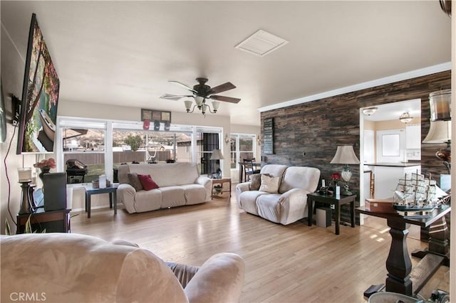 living room with ceiling fan and light wood-type flooring