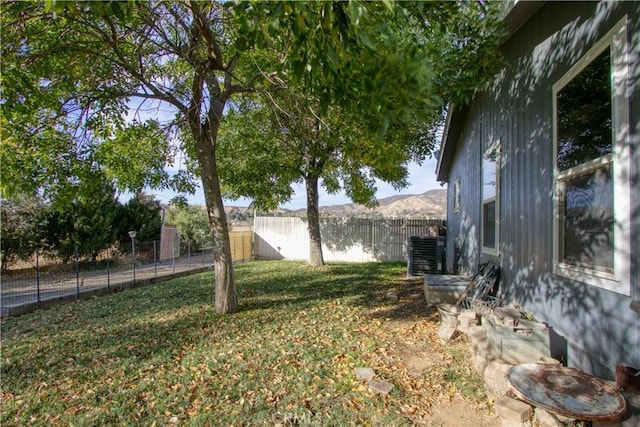 view of yard featuring central air condition unit and a mountain view