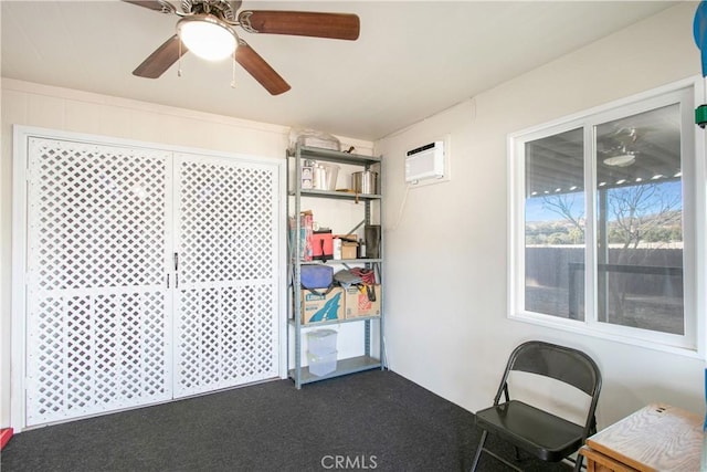 unfurnished office with ceiling fan, dark carpet, and an AC wall unit