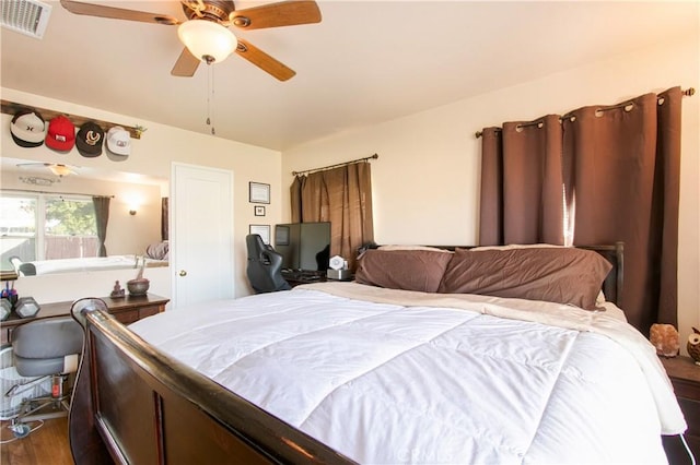 bedroom featuring ceiling fan and hardwood / wood-style flooring