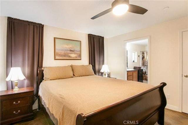 carpeted bedroom with ensuite bath and ceiling fan