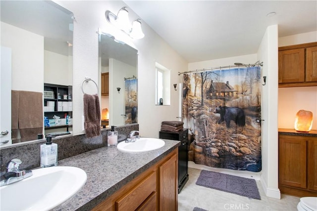 bathroom featuring tile patterned flooring, vanity, and toilet